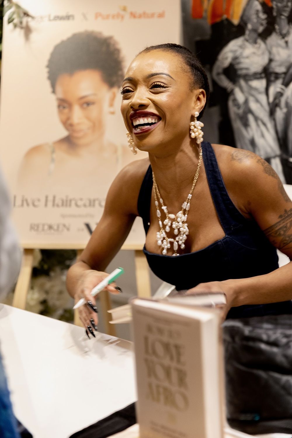 Paige signing copies of How to Love Your Afro