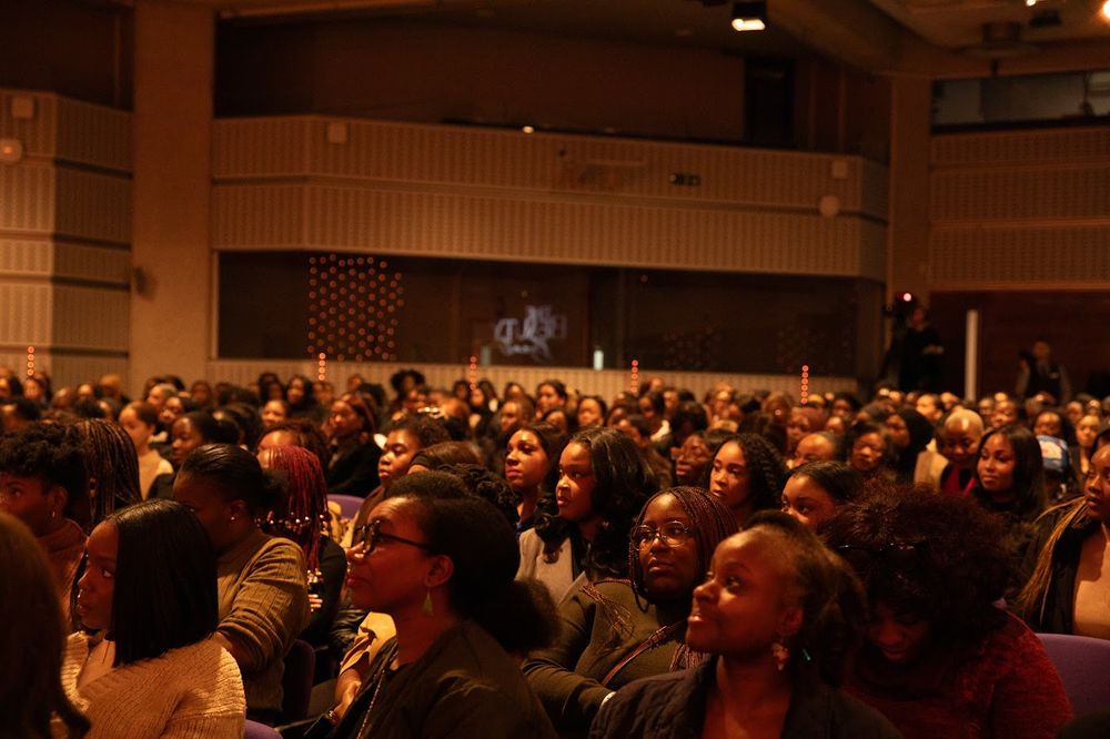 A full auditorium listening to Paige
