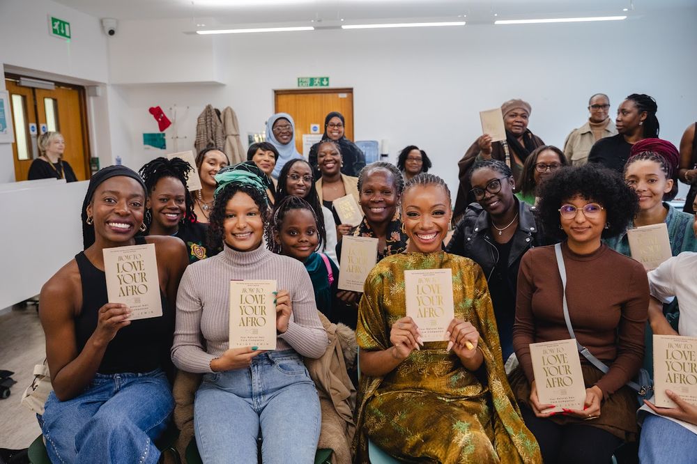 A group holding Paige&rsquo;s book at an event