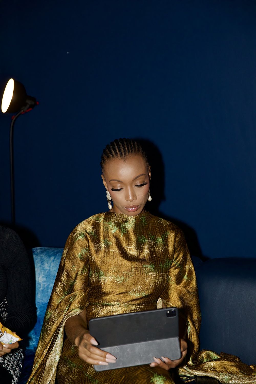 Paige in gold with a tablet