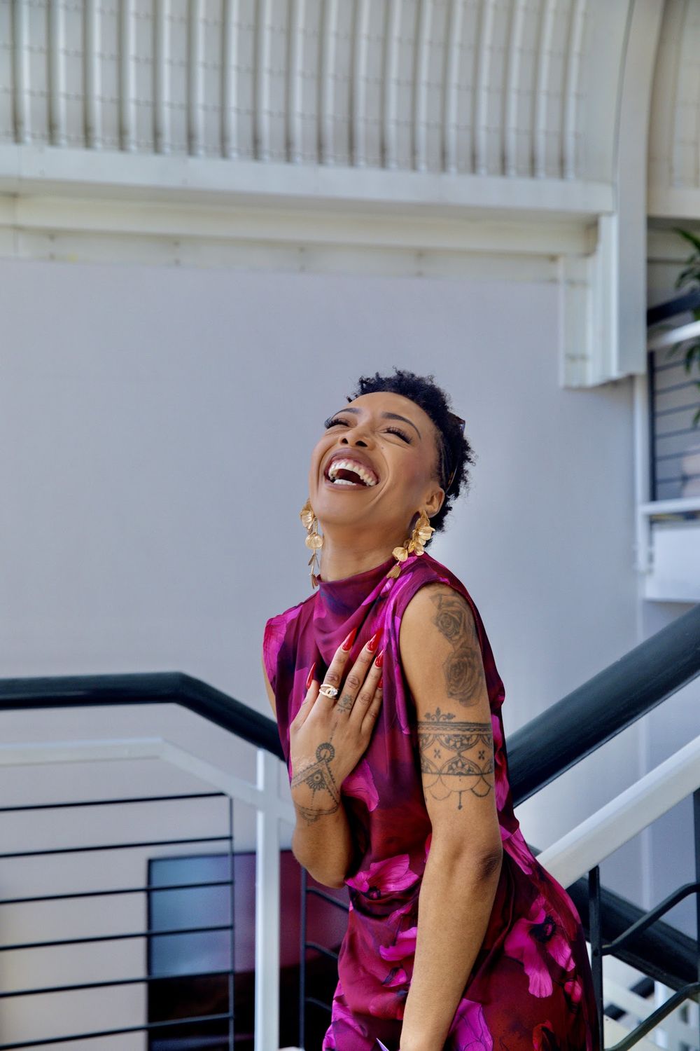 Paige laughing in a raspberry dress